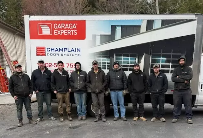 Champlain Door Systems technicians in front of a truck services